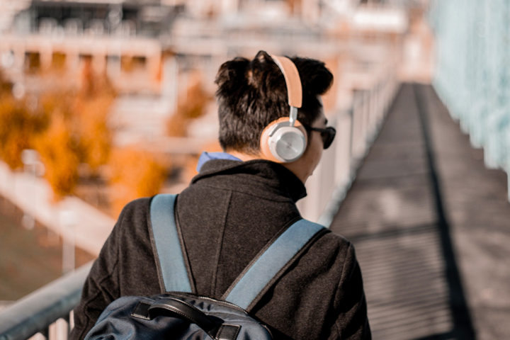 main with headphones and backpack
