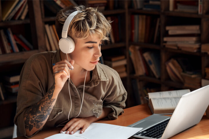 college student with headphones and laptop